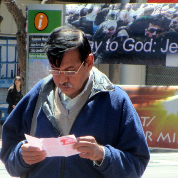Man reading tract given to him at UN Plaza